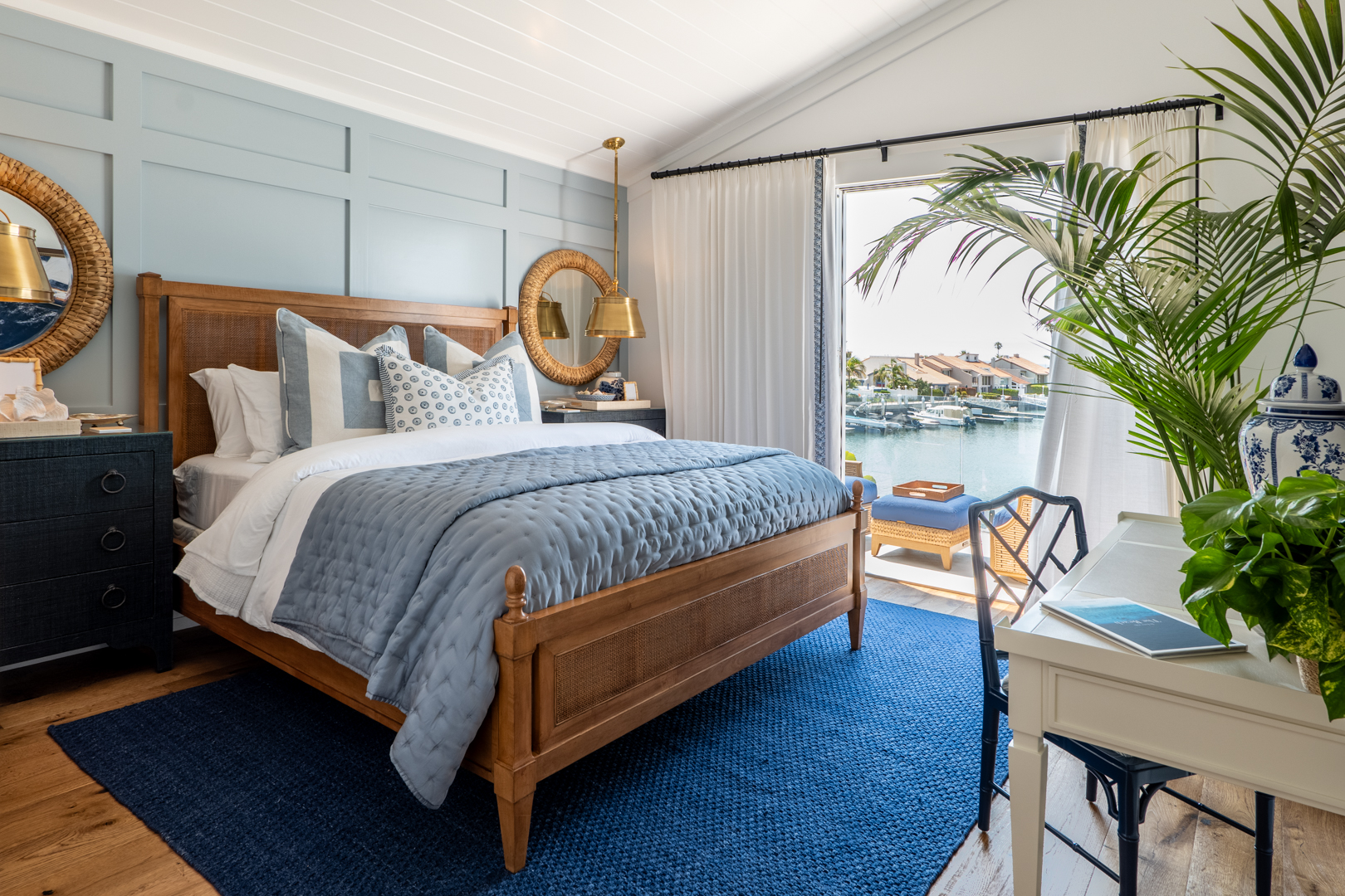 Coastal guest bedroom design with blue color palette and ocean view