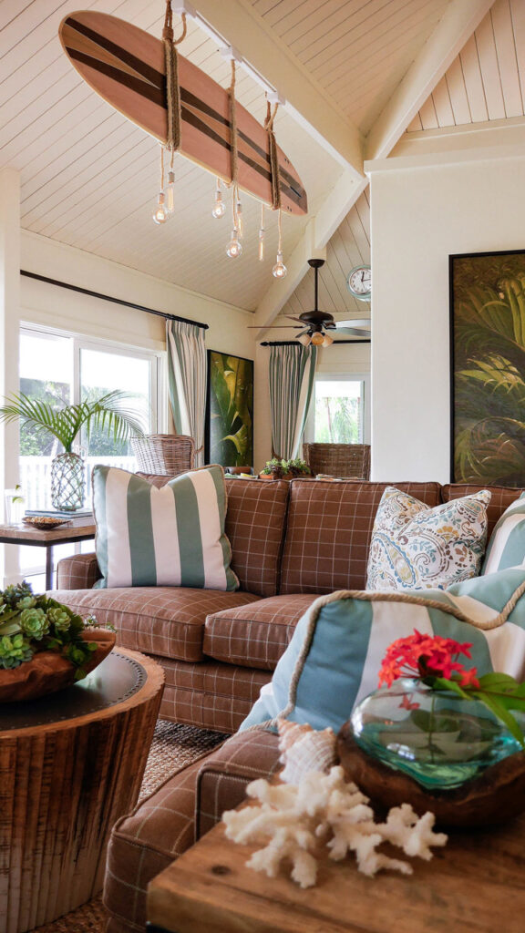 Kauai vacation rental living room design with surfboard chandelier and coastal blue and green accents