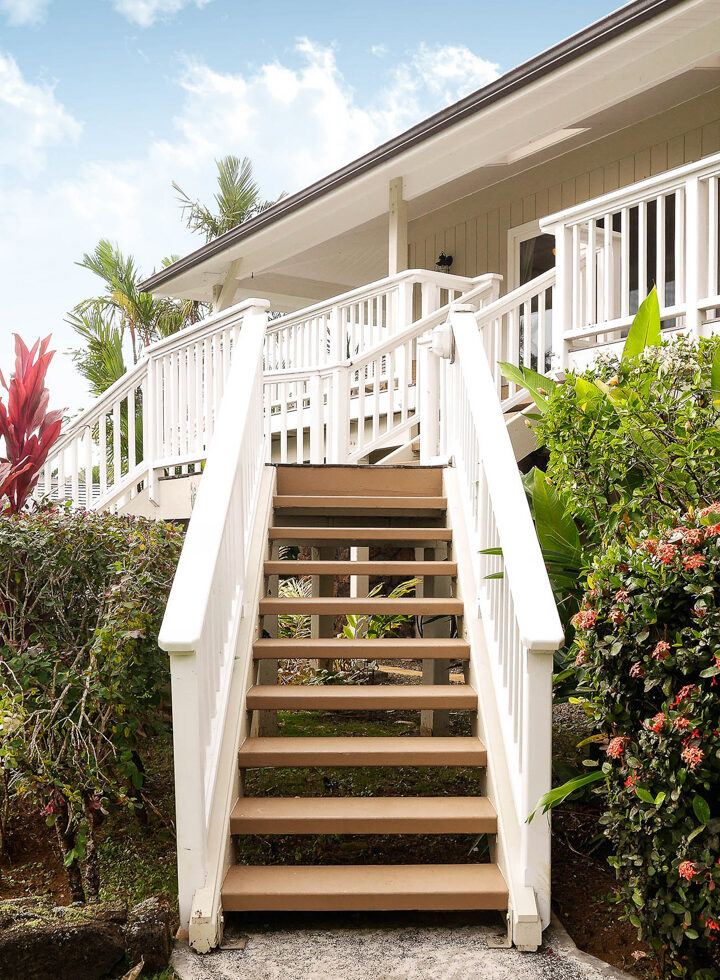 Kauai vacation rental exterior with tropical foliage and elevated front entry