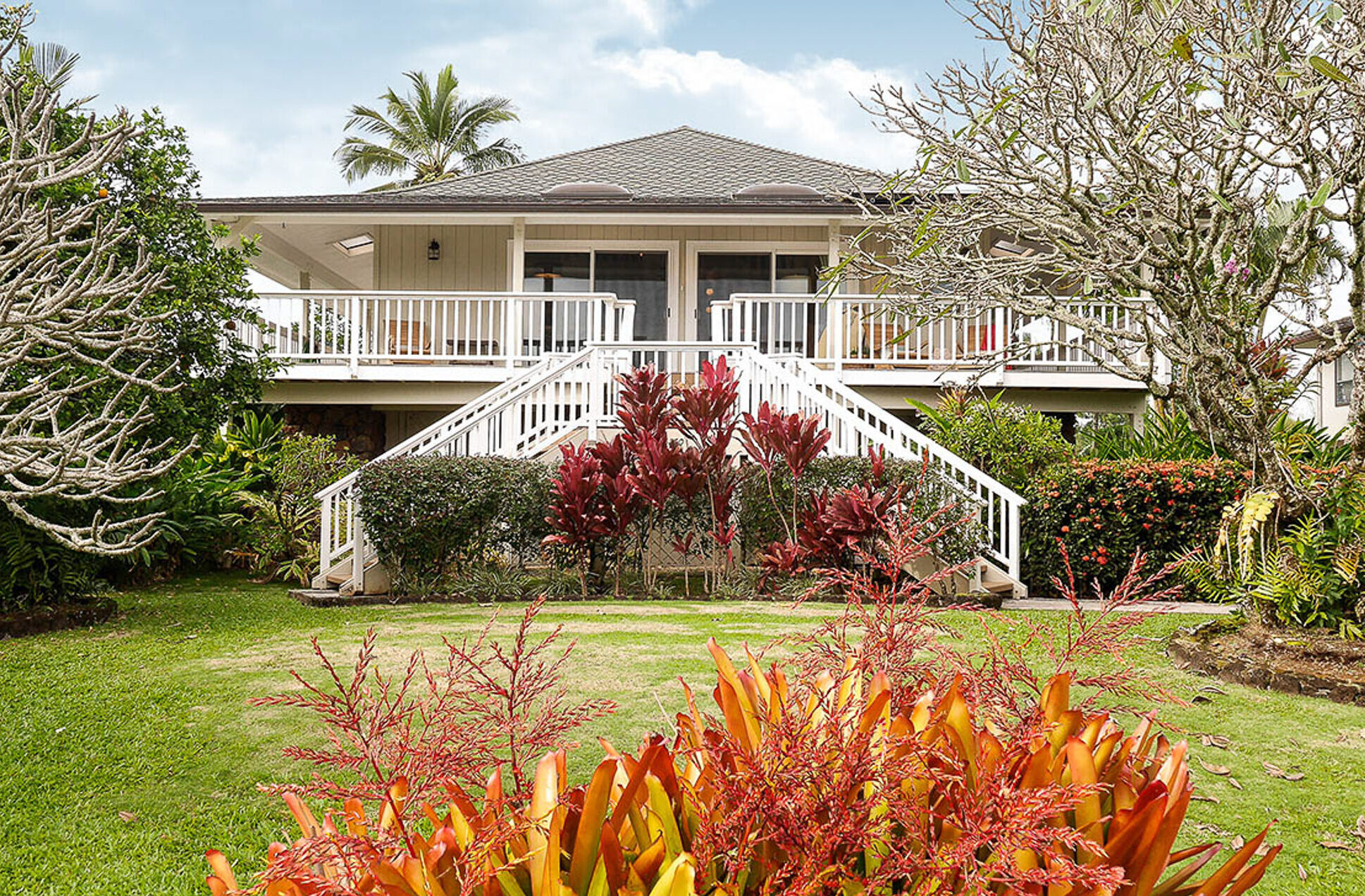 Kauai vacation rental exterior with dual staircases and elevated front entry