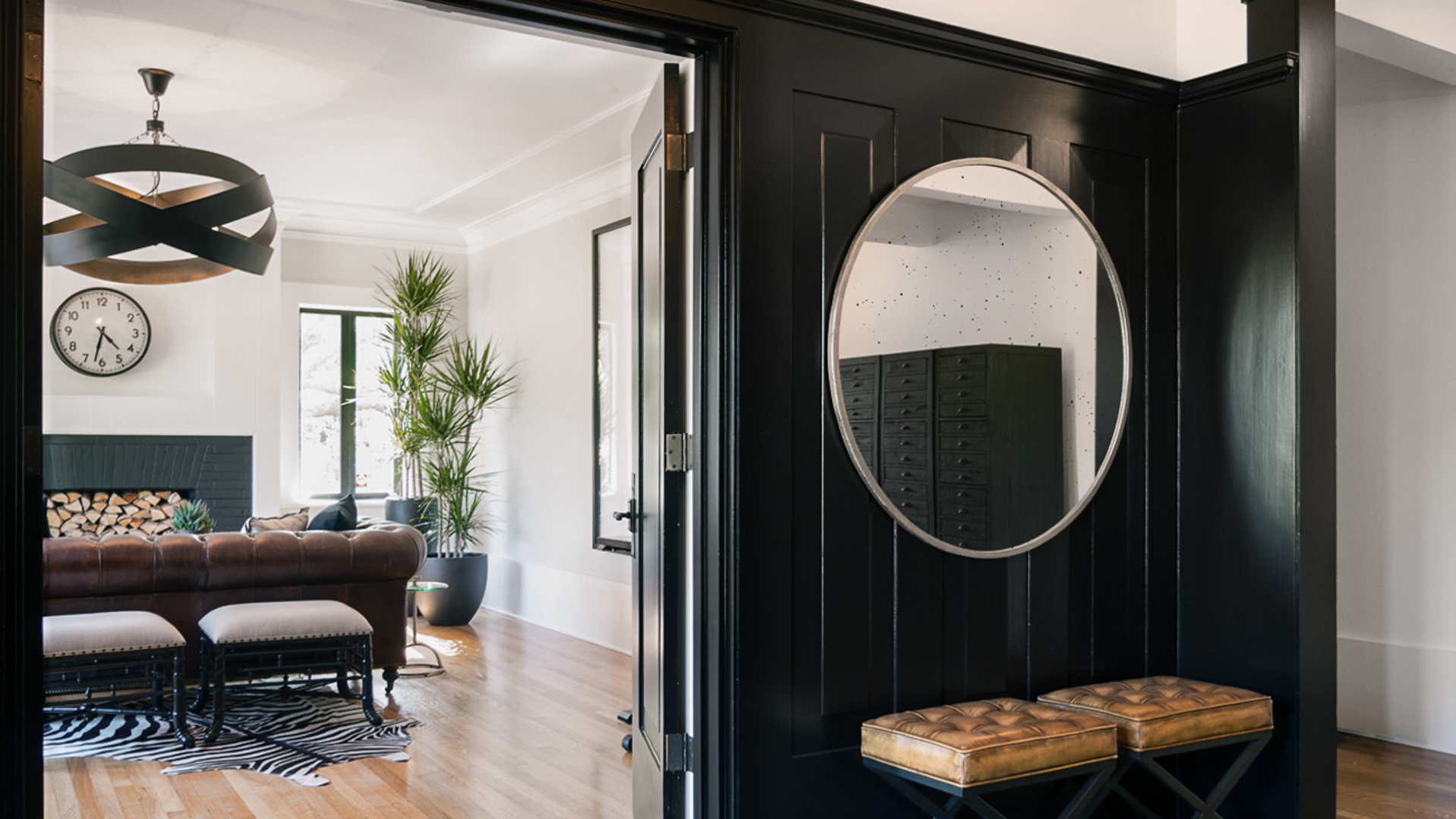 Commercial office space designed with black, gold, and rich wood accents
